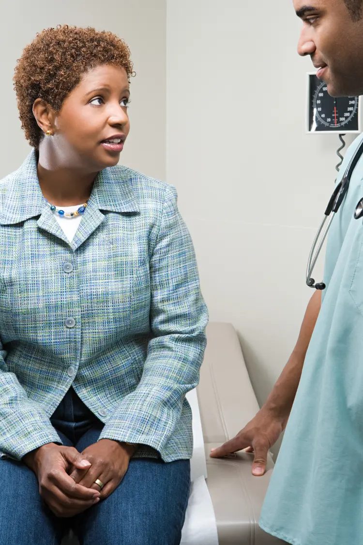 Lady in blue blazer asks doctor how to save money on prescriptions.